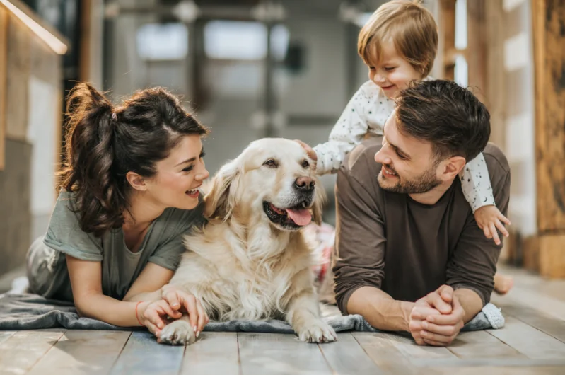 my-home-navigators-family-with-dog-celebrating-home-sale